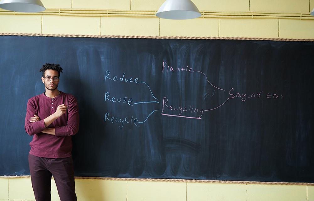 Man standing in front of chalkboard